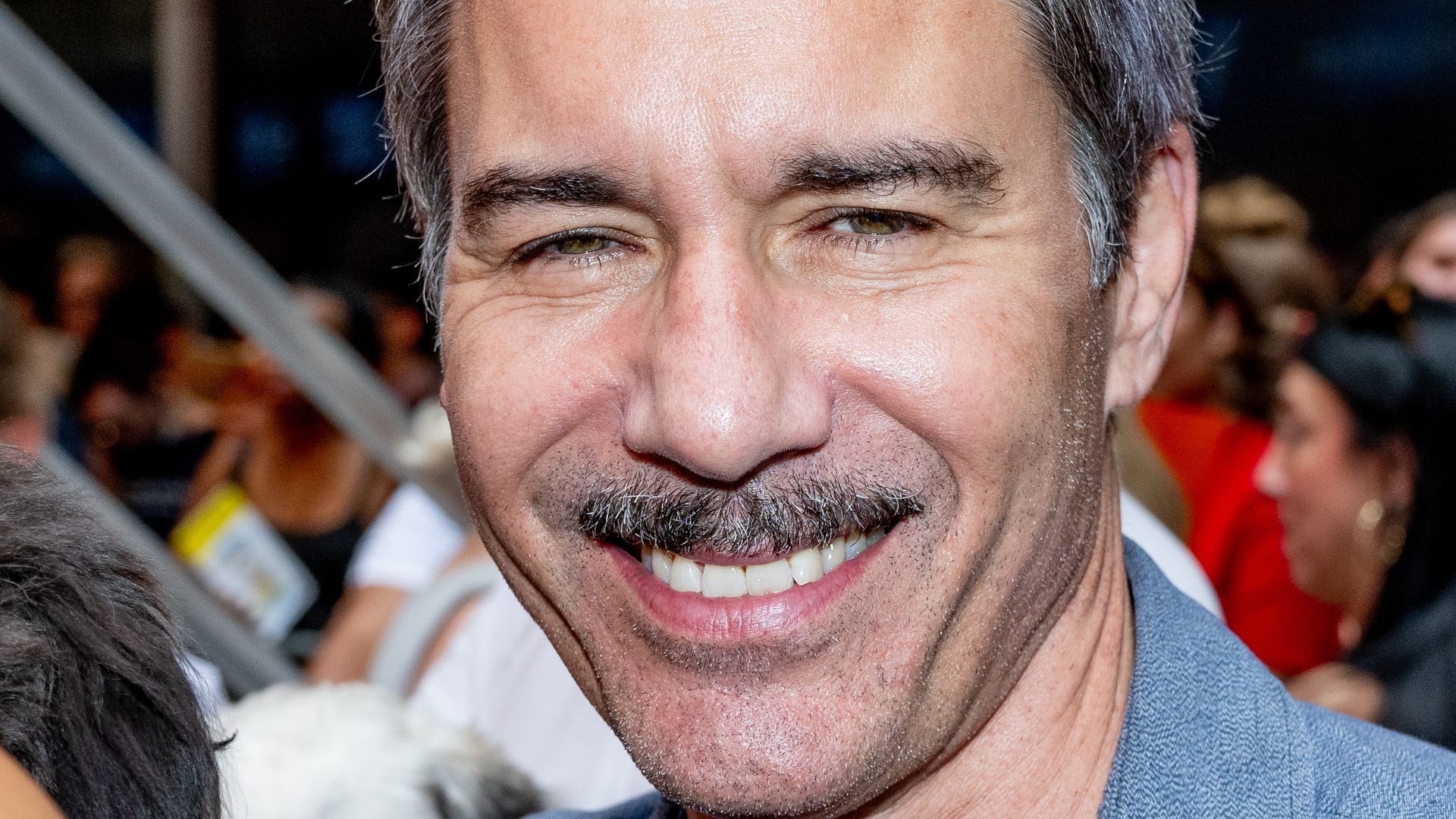 Eric McCormack smiling in a close-up photo