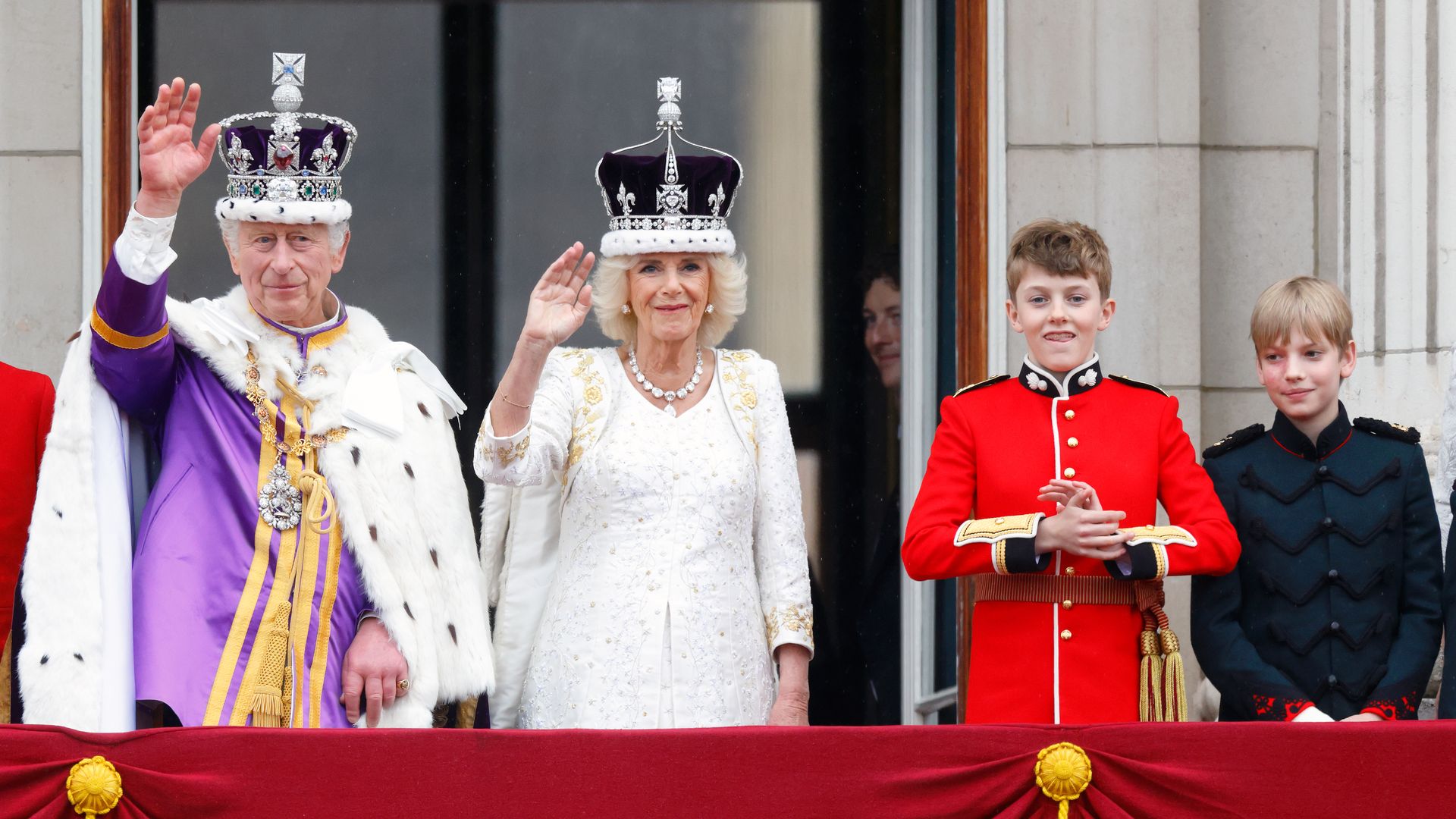 King Charles III, Queen Camilla, Freddy Parker Bowles and Gus Lopes watch an RAF flypast following the coronation