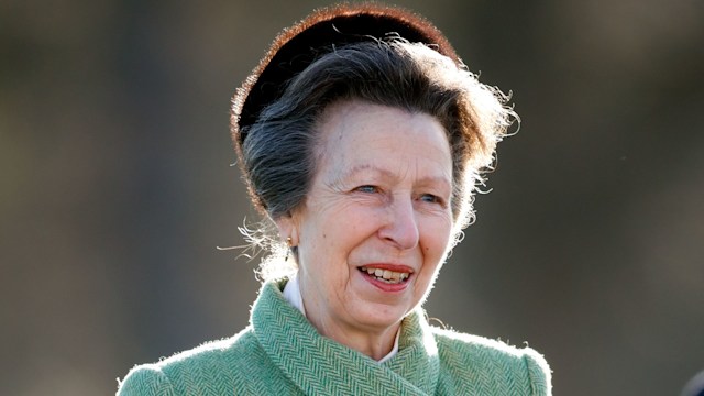 Princess Anne smiling in green tweed coat