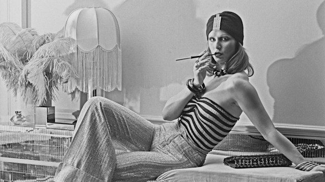 TA model wearing wide-legged trousers, a striped tube top and a turban-style hat at the Biba boutique in London, UK, 6th September 1973)