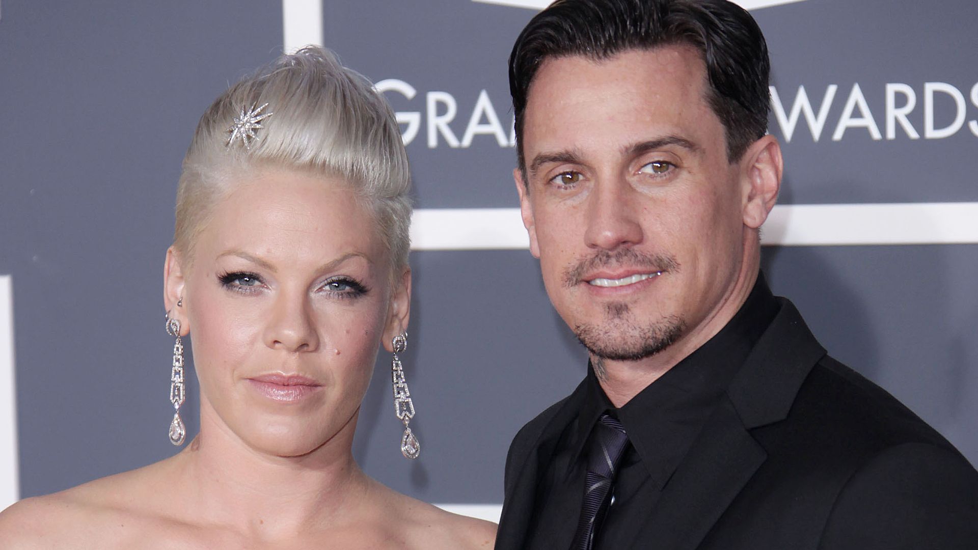 Pink in a silver dress with her husband Carey Hart in a black suit