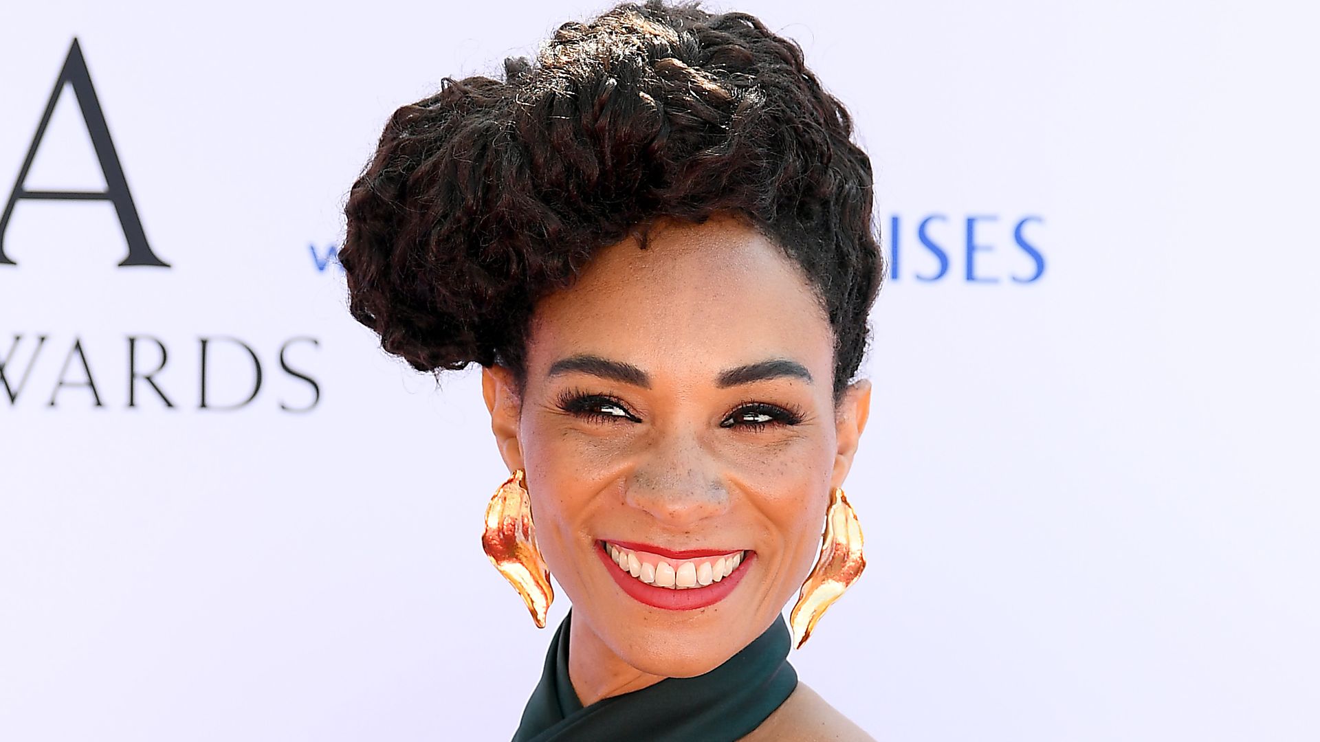 Michelle Ackerley posed hand on hip in black dress