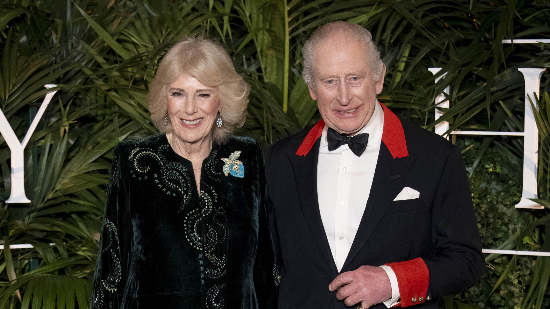 Queen Camilla in a dress and King Charles in a tuxedo