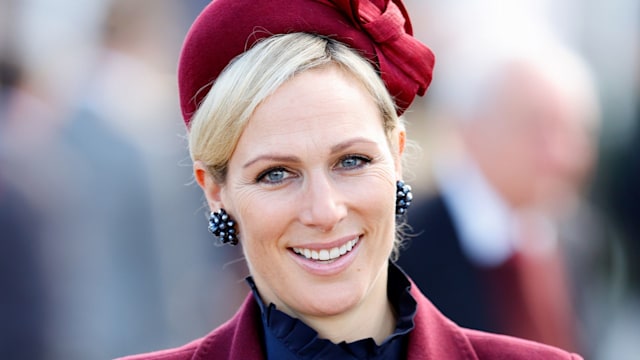 Zara Tindall in burgundy coat and fascinator