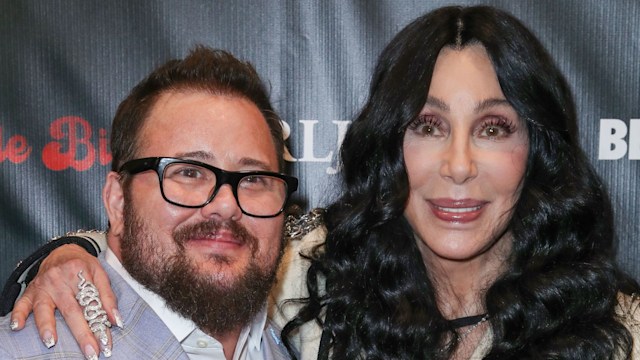 Chaz Bono and Cher smiling on the red carpet