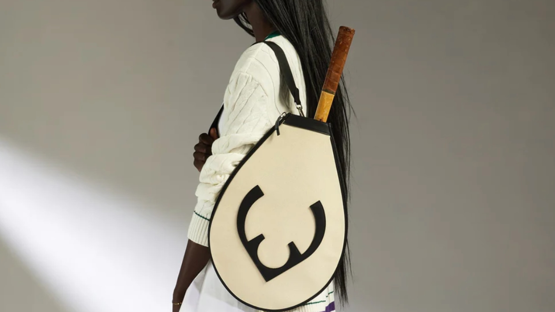 A model poses with a Antler tennis racket bag 
