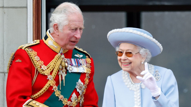 King Charles standing with the Queen on Buckingham Palace balcony