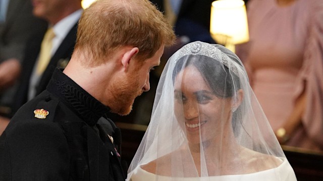 Prince Harry and Meghan Markle smiling at each other during their marriage in St George's Chapel
