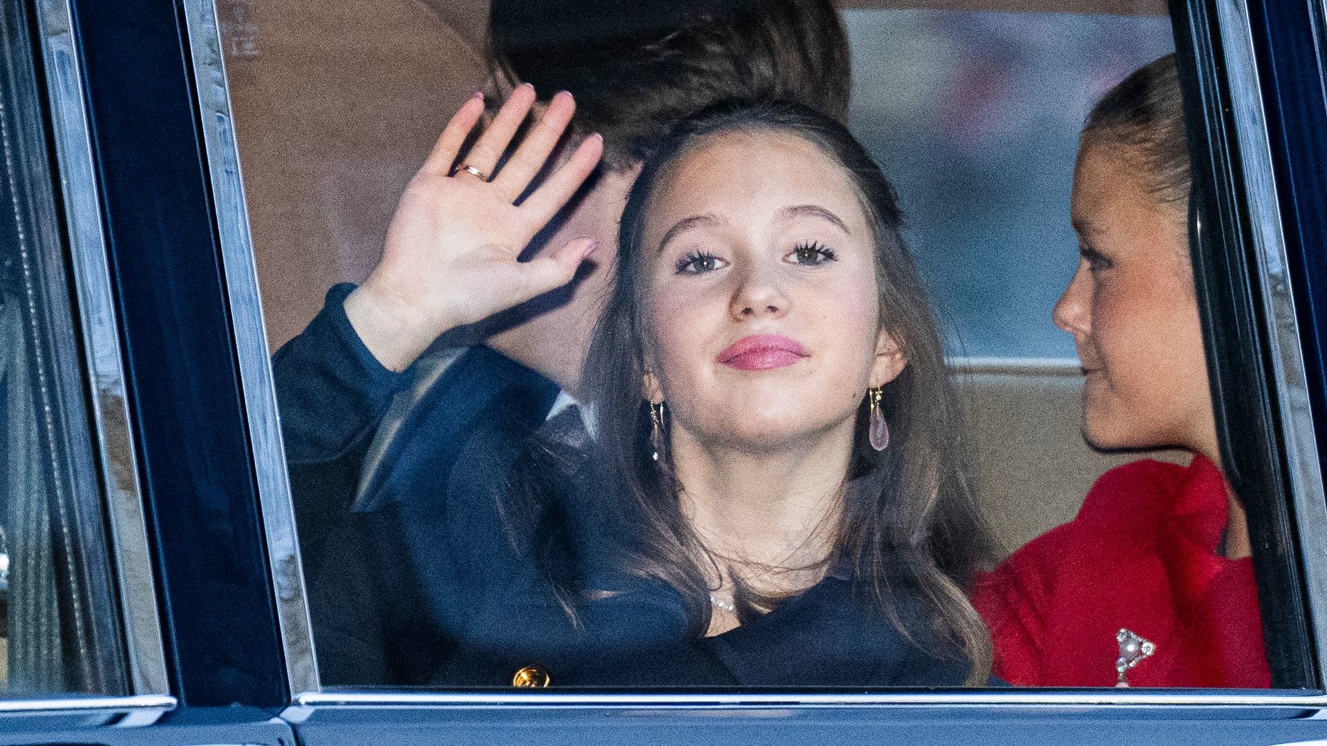 Princess Josephine waves as she and her siblings Prince Vincent, Princess Isabella and Crown Prince Christian arrive at Amalienborg after the proclamation of HM King Frederik X and HM Queen Mary of Denmark 
