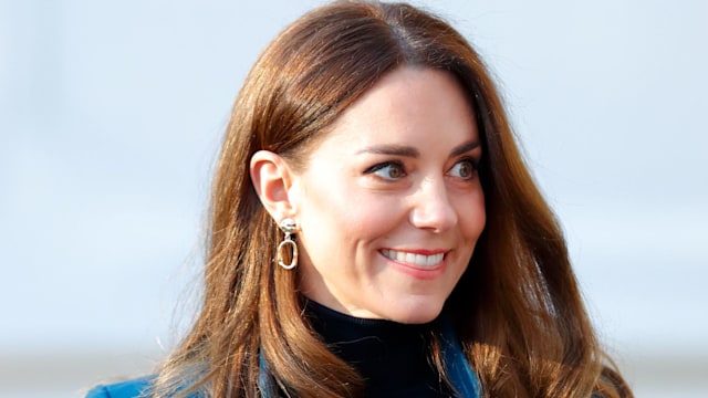 Catherine facing right looking surprised in blue coat