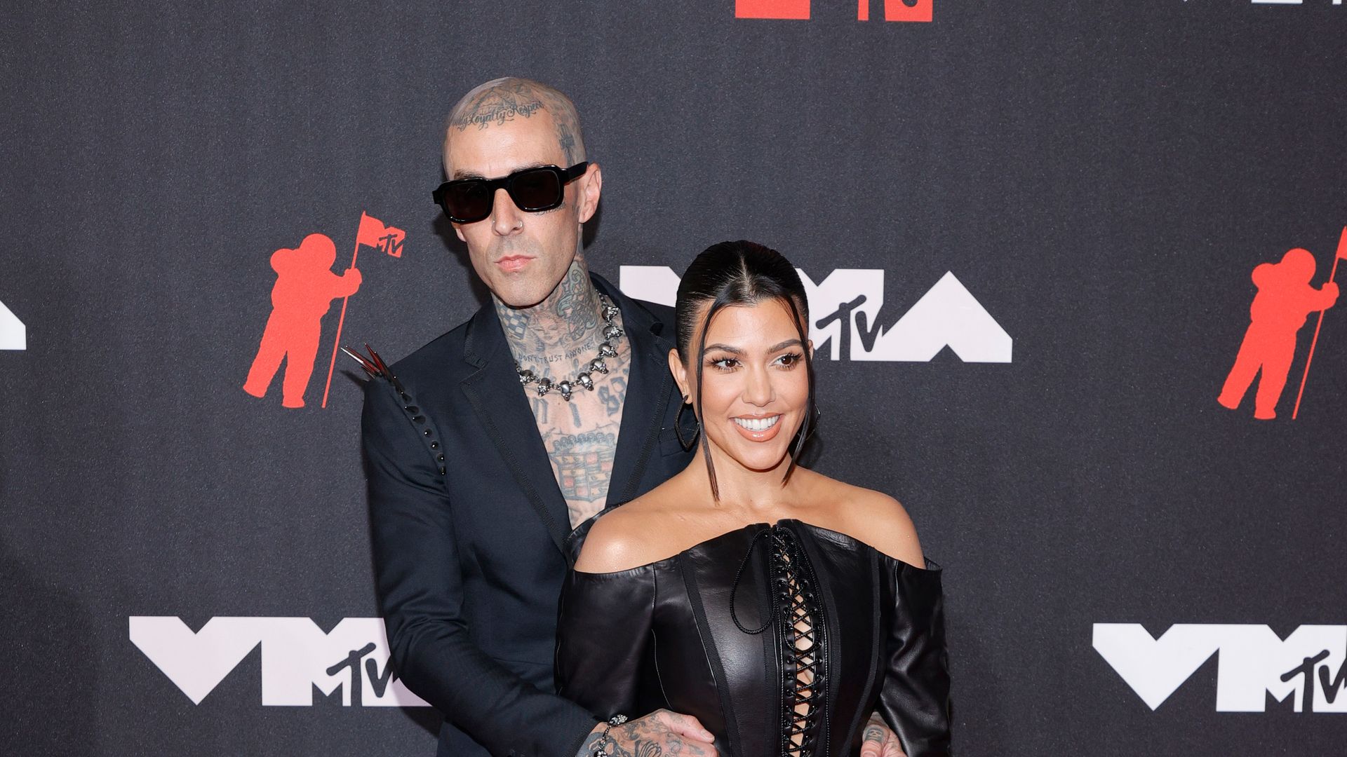 Travis Barker and Kourtney Kardashian on red carpet 