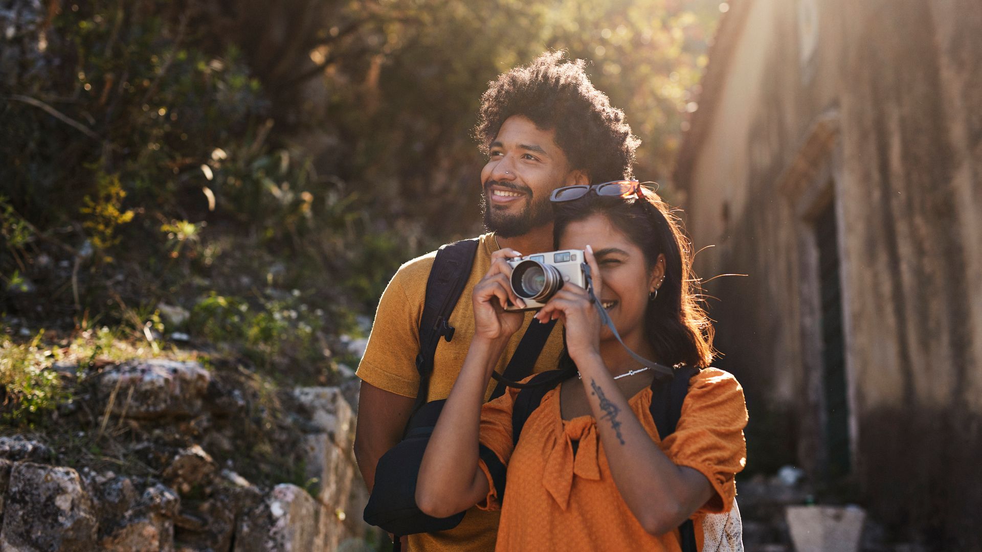 Woman photographing through camera by boyfriend