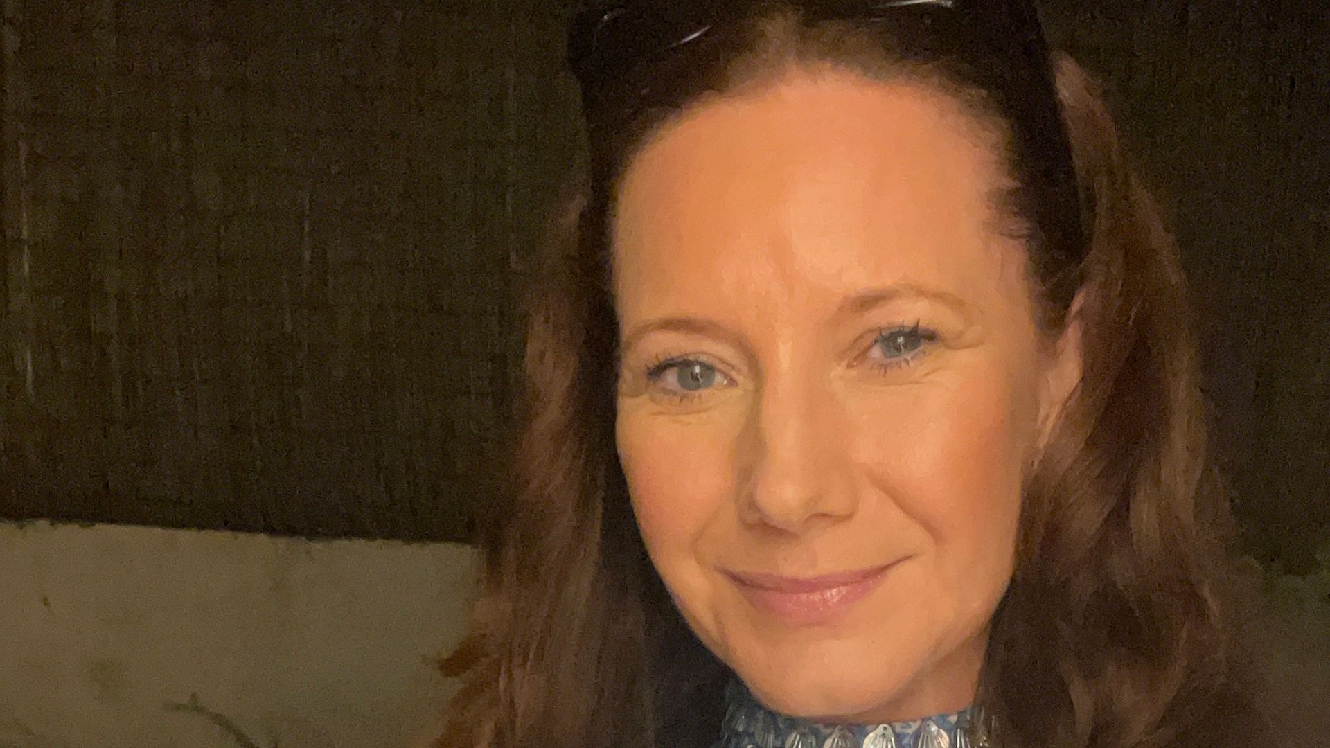 woman smiling in a glittery blue dress