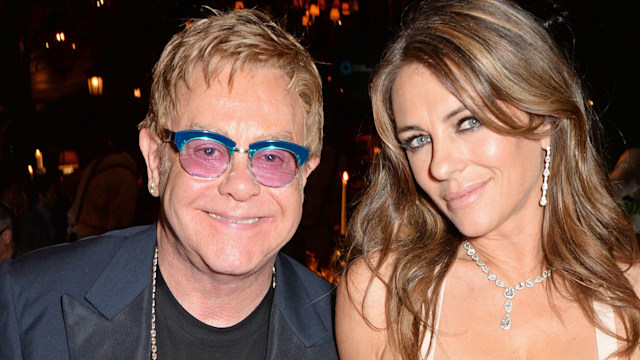 Elizabeth Hurley straddles Elton John in plunging dress you won't believe