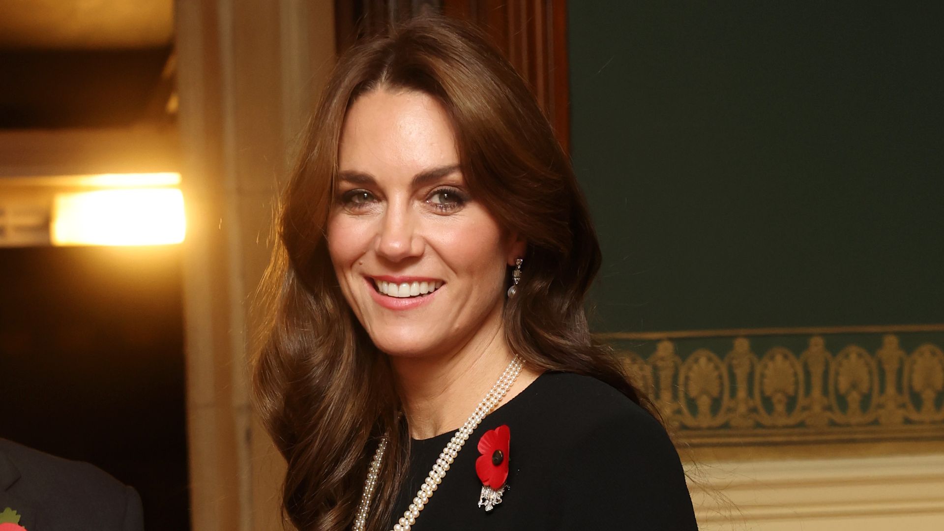 Kate Middleton in a black dress with pearl necklace