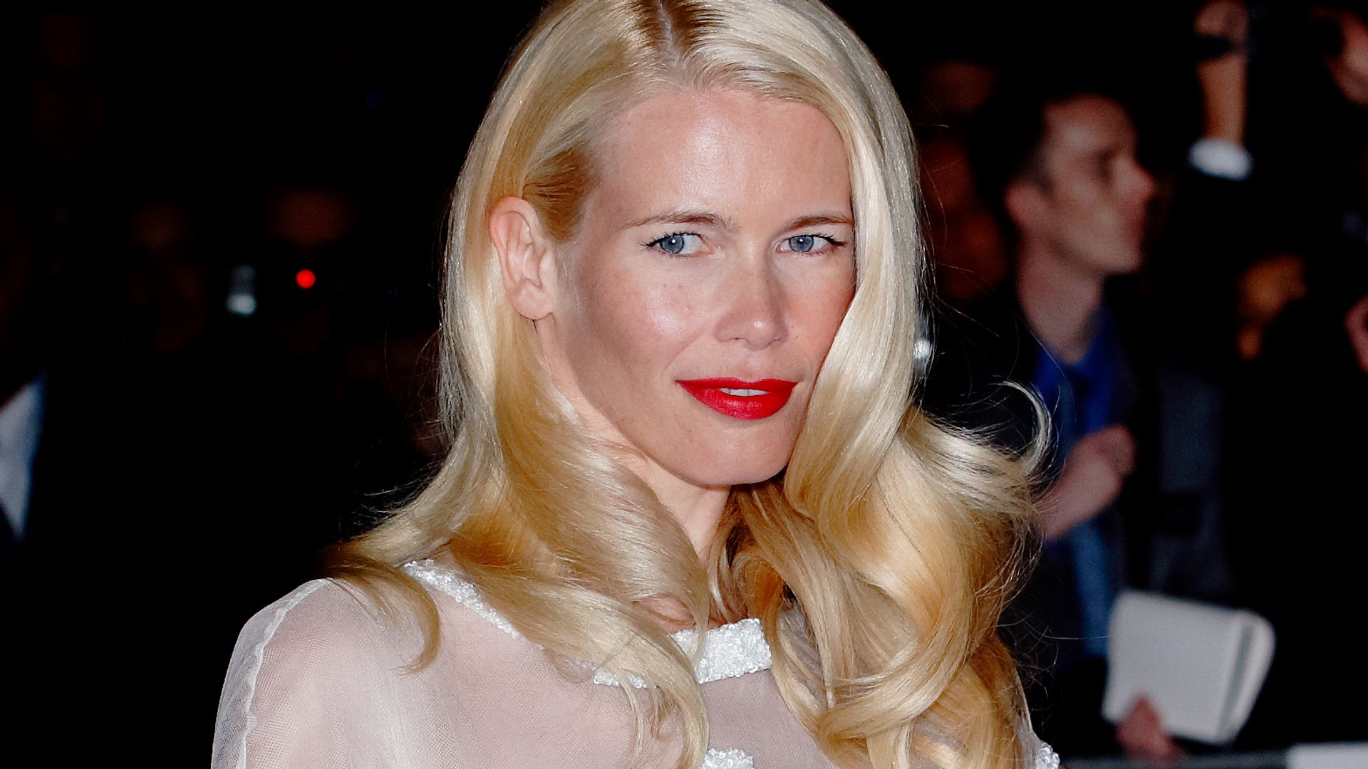Claudia Schiffer in a white dress and red lipstick at the Golden Age of Couture Gala