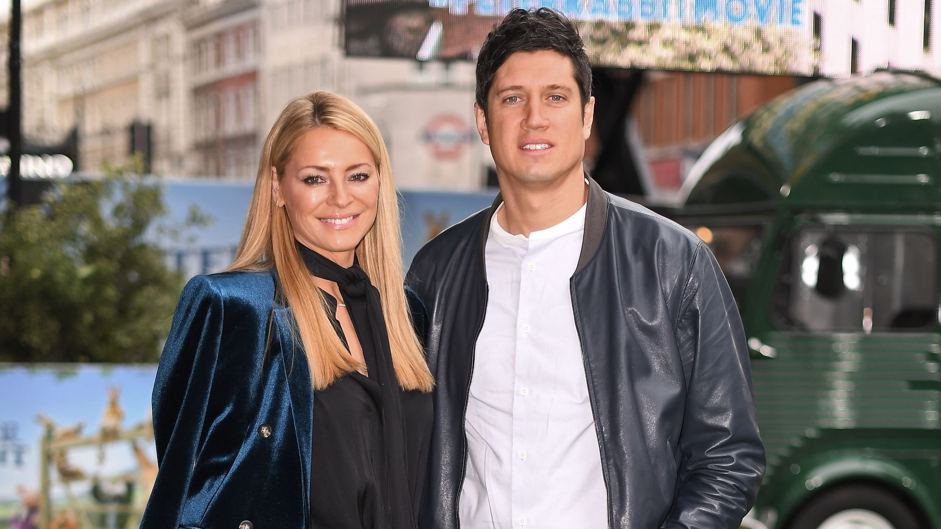 Tess Daly and Vernon Kay in leather standing in grassy field