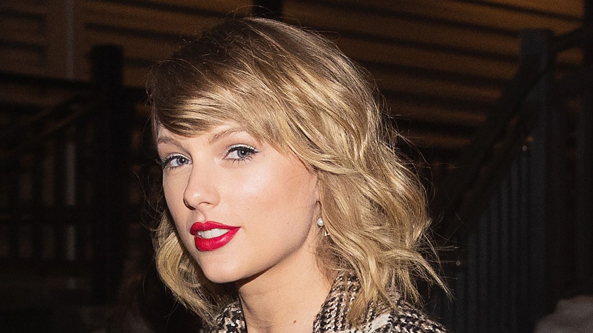 Taylor Swift sports a matching tweed dress and over coat 