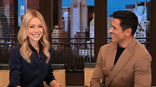 LIVE WITH KELLY AND MARK - Kelly Ripa and Mark Consuelos captured laughing together at their hosting desk