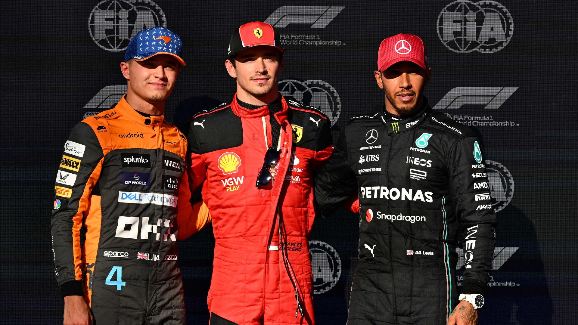 Lando Norris, Charles Leclerc and Lewis Hamilton standing in a line