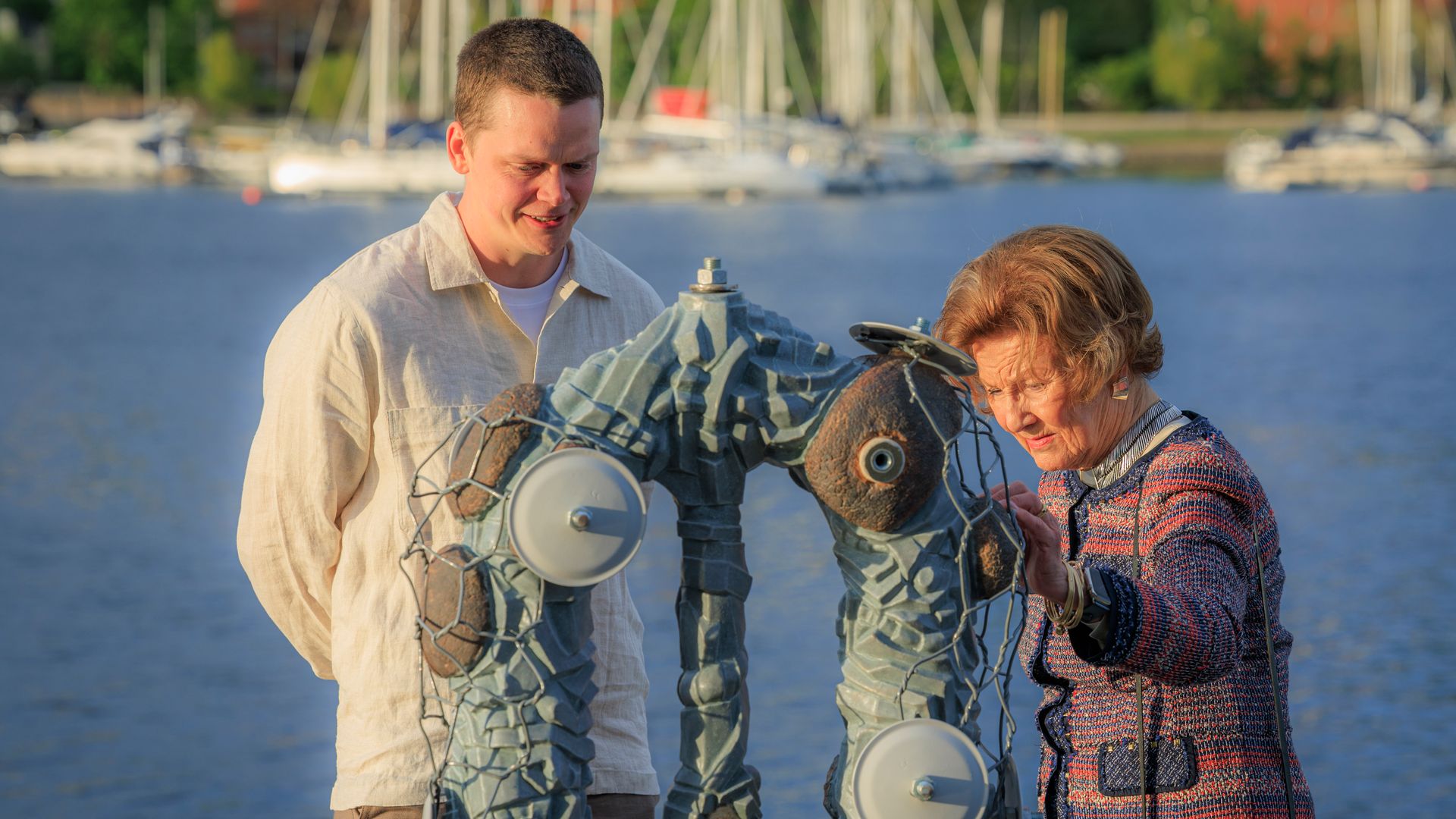 Queen Sonja and a man looking at a piece of art