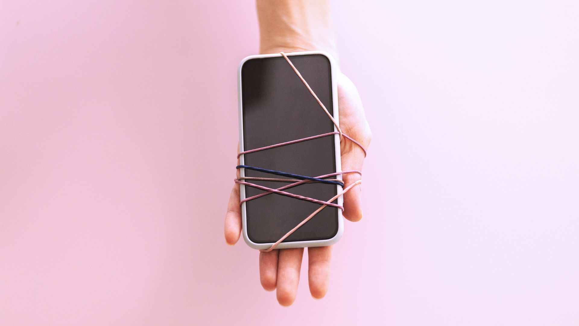 hand with phone attached by rubber bands