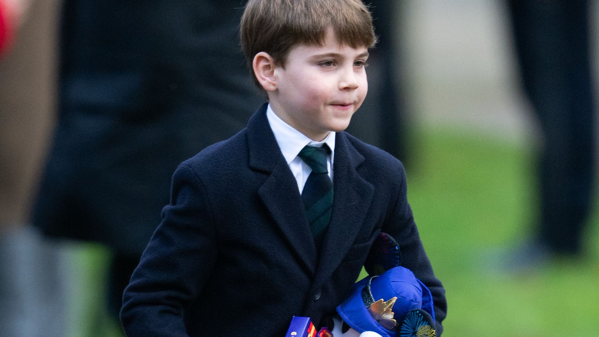 Prince Louis carrying presents