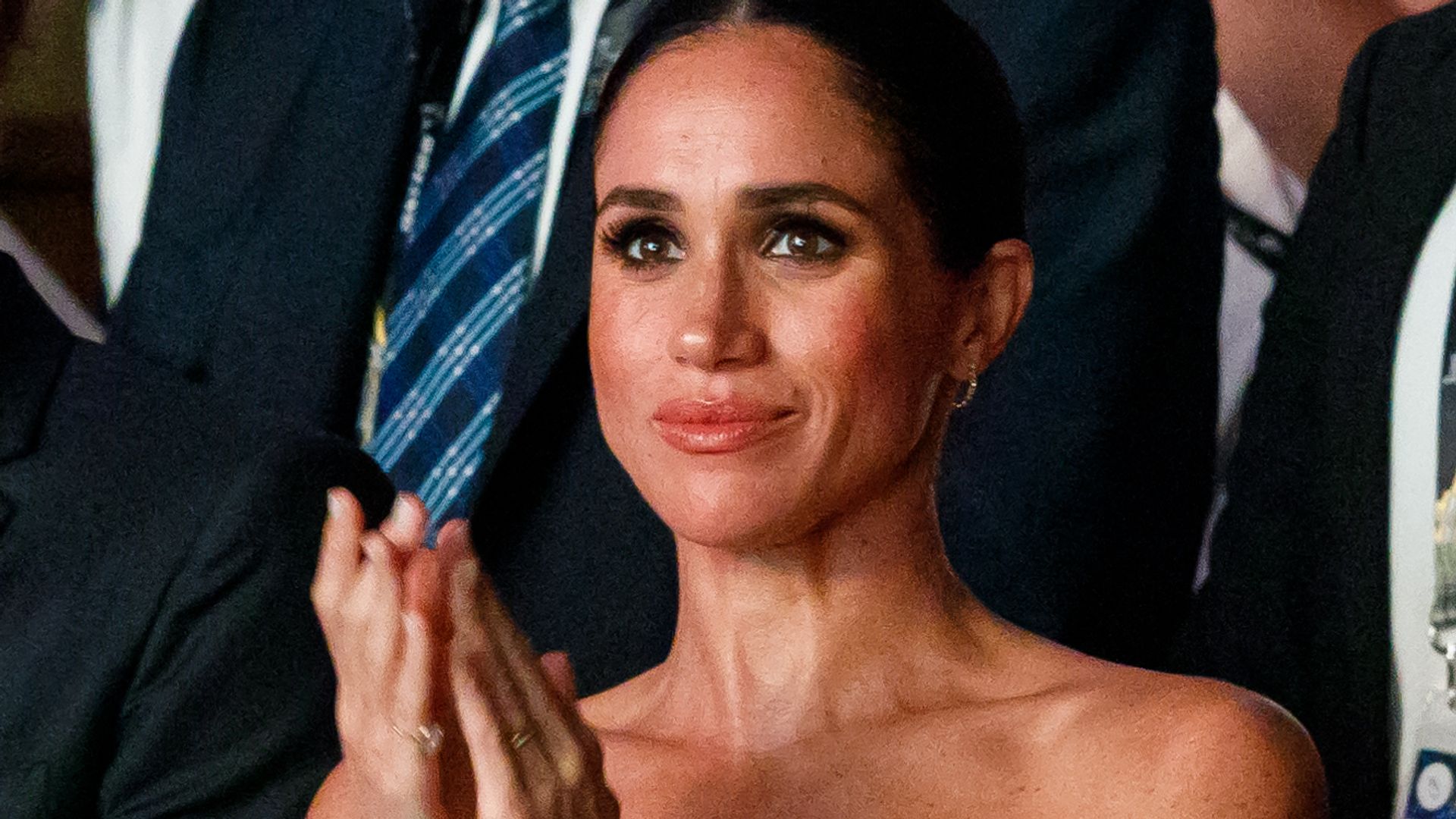 Meghan Markle in a strapless dress clapping