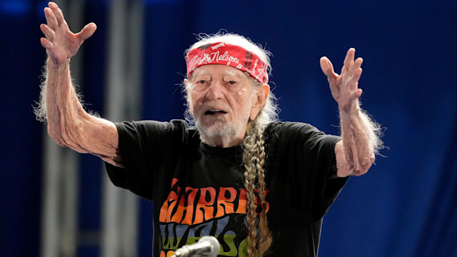 Willie Nelson blows a kiss to the crowd after performing at a Vice President Kamala Harris rally 