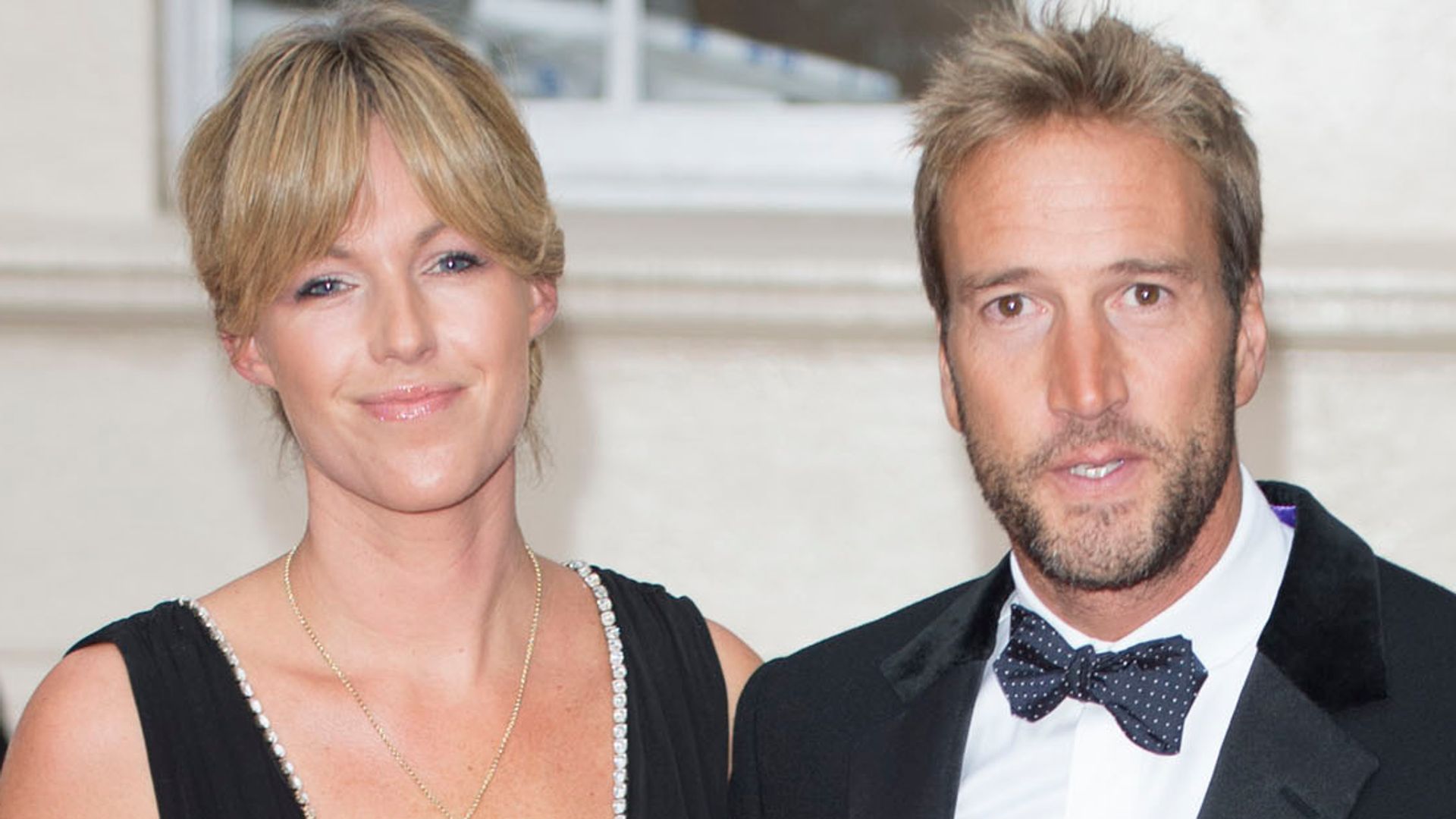 Ben Fogle in a black suit and bow tie with wife Marina in a black mini dress