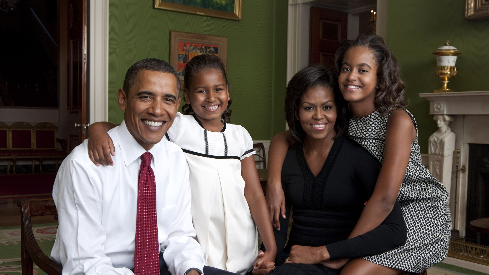 U.S. President Barack Obama, daughter Malia Obama, first lady Michelle Obama and daughter Sasha Obama sit for portrait in the Green Room of the White House
