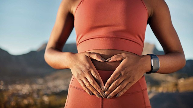 Woman holding stomach on run