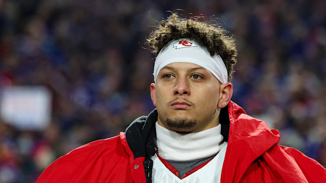 Patrick Mahomes #15 of the Kansas City Chiefs looks on from the sideline during the national anthem prior to an NFL divisional round playoff football game against the Buffalo Bills at Highmark Stadium on January 21, 2024 in Orchard Park, New York