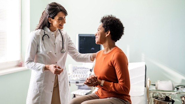 Female medical practitioner reassuring a patient