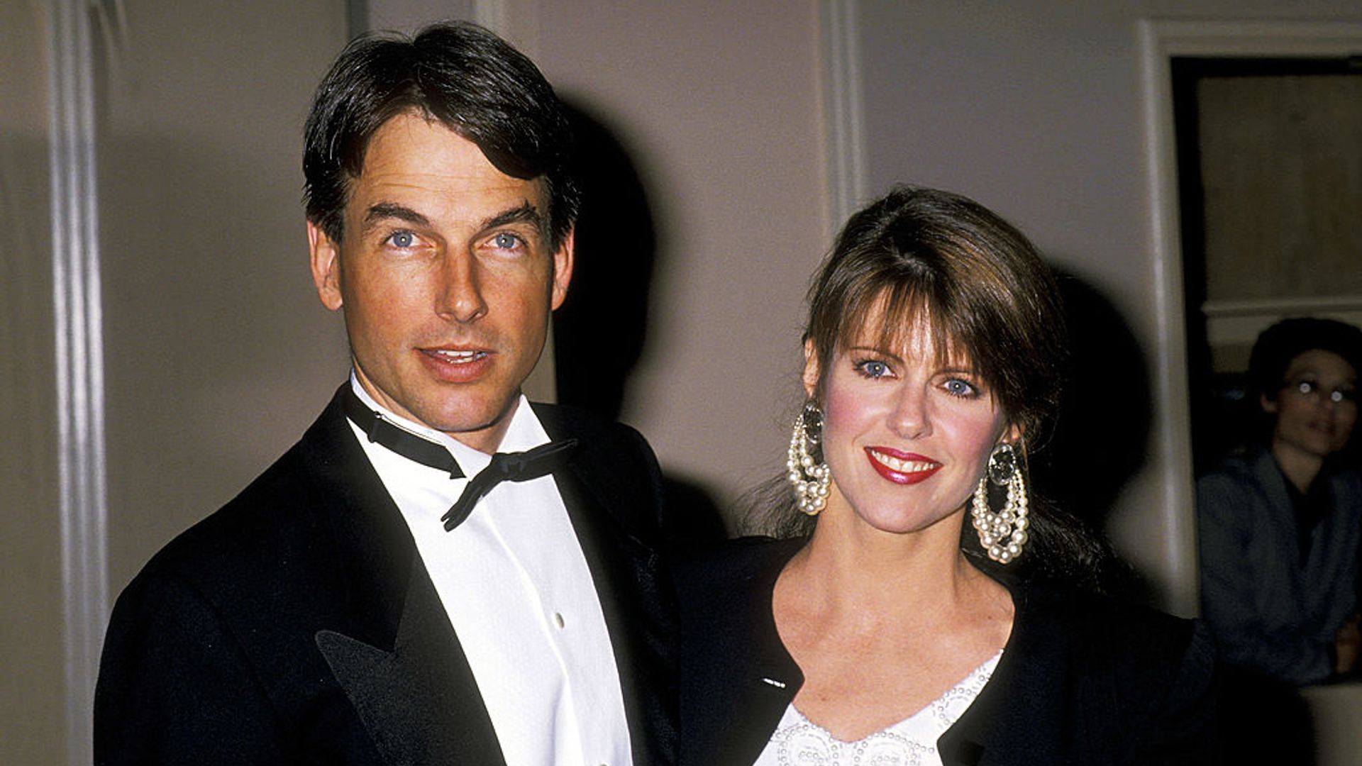 Mark Harmon wearing a tux and Pam wearing a white dress and a black jacket at an event hosted by theAmerican Film Institute