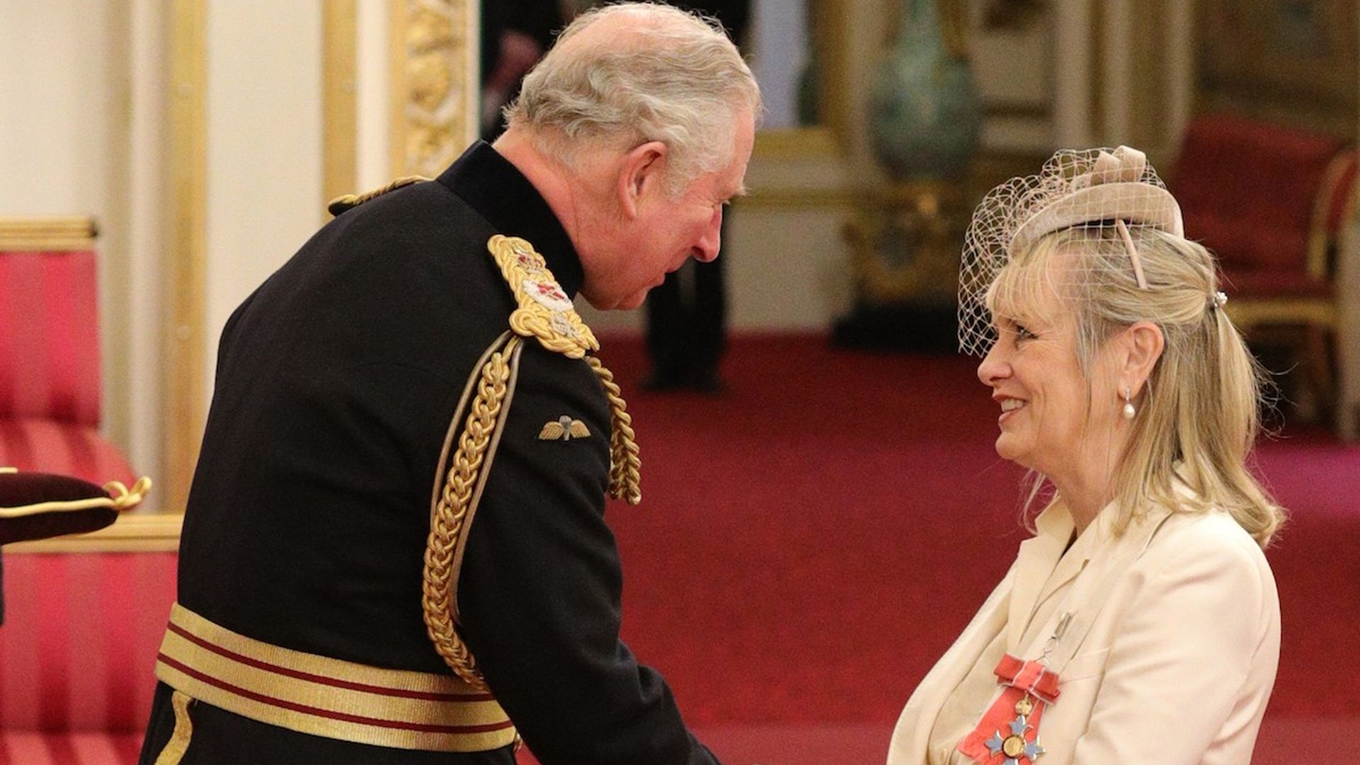 Dame Twiggy! Iconic fashion model accepts her new title at Buckingham Palace in striking white tuxedo