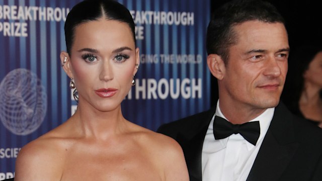 Katy Perry in an off-the-shoulder black dress and Orlando Bloom in a tux