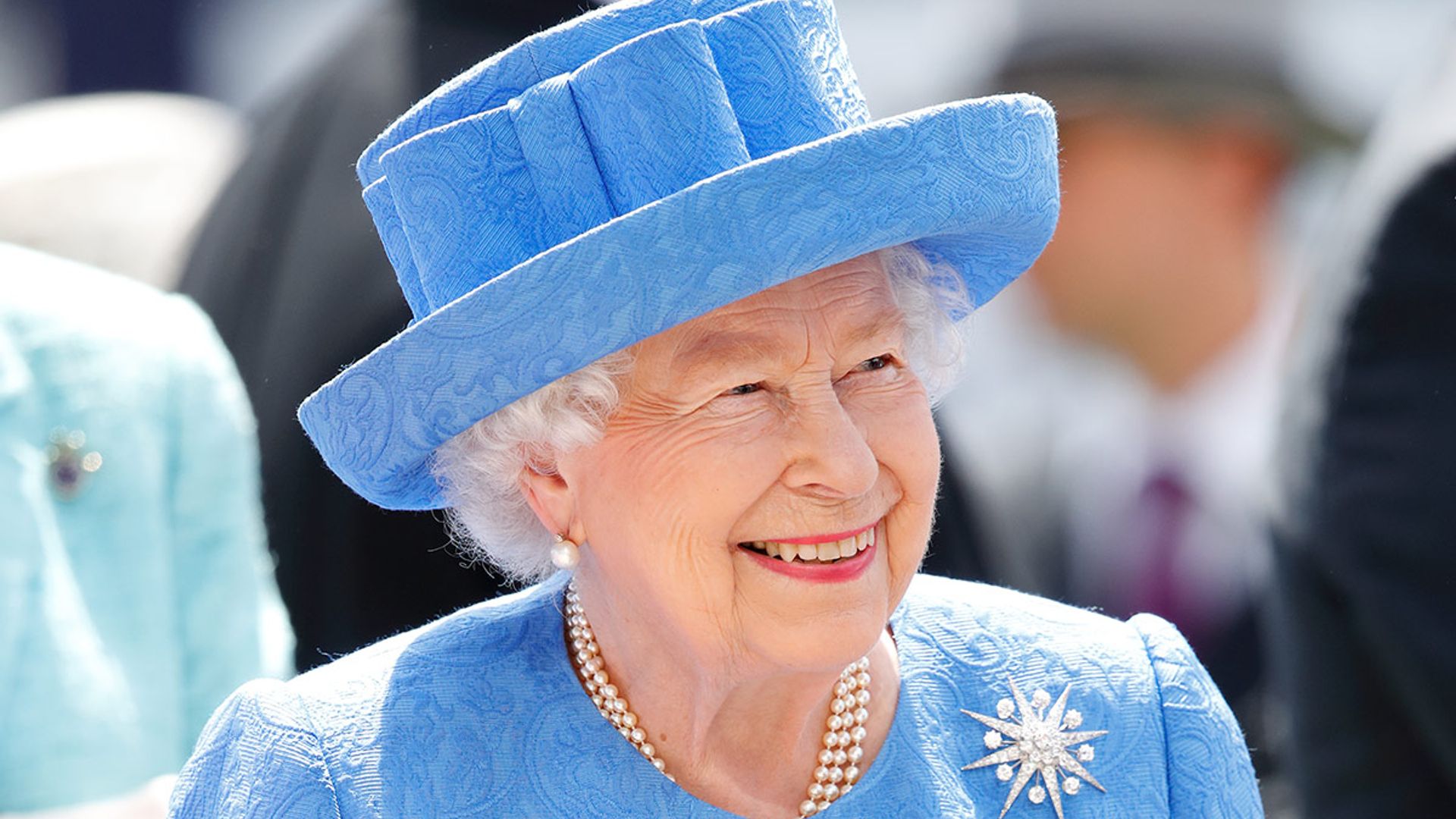 the queen smiling in blue