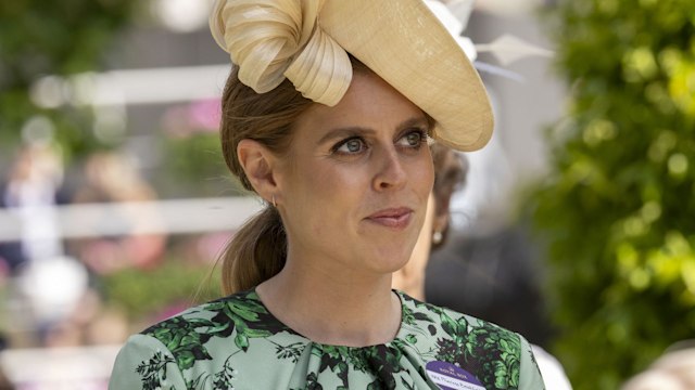 Princess Beatrice wearing yellow hat with green dress while observing trophy ceremony at Royal Ascot
