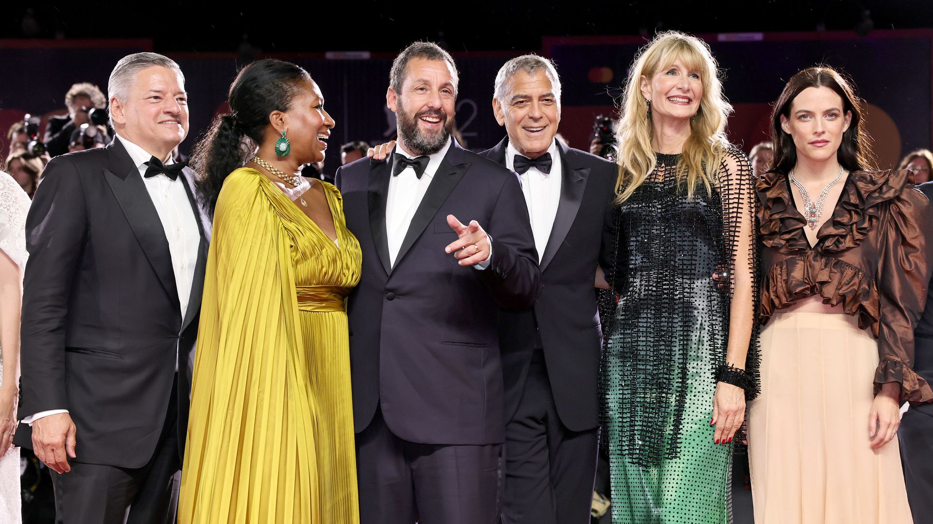 Ted Sarandos, Nicole Avant, Adam Sandler, George Clooney,  Laura Dern and Riley Keough attend the "Jay Kelly" red carpet during the 82nd Venice International Film Festival on August 28, 2025 in Venice, Italy