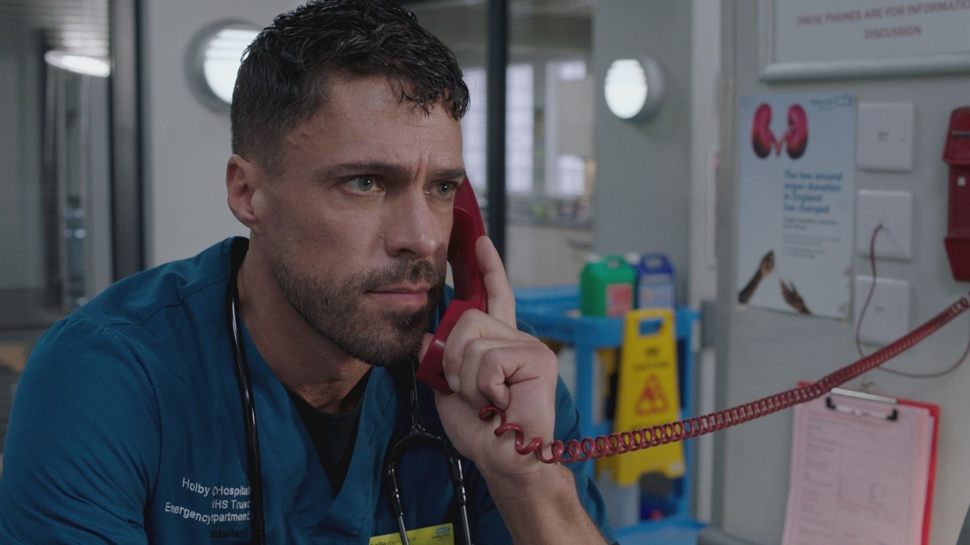 Olly Rix in Casualty answering a phone