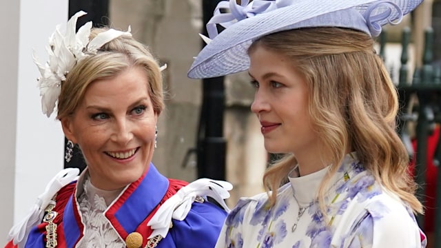 Duchess Sophie in white ceremonial robes smiling at her daughter Lady Louise