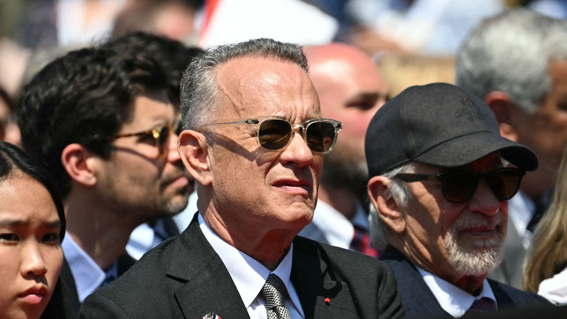 US actor Tom Hanks (C) and US director Steven Spielberg (R) attend the US ceremony marking the 80th anniversary of the World War II "D-Day" Allied landings in Normandy in 2024