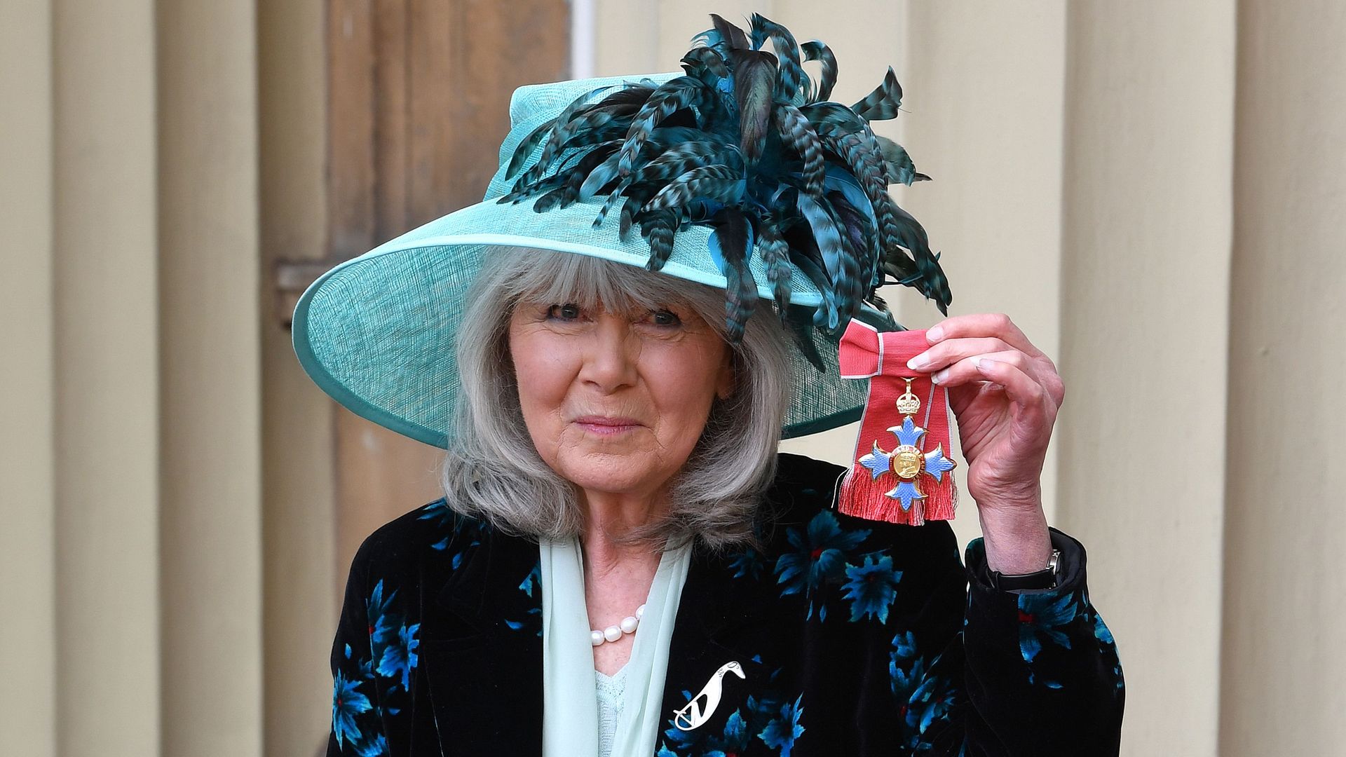 Author Jilly Cooper poses with her medal after she was appointed a Commander of the Order of the British Empire (CBE) at an investiture ceremony at Buckingham Palace in London 