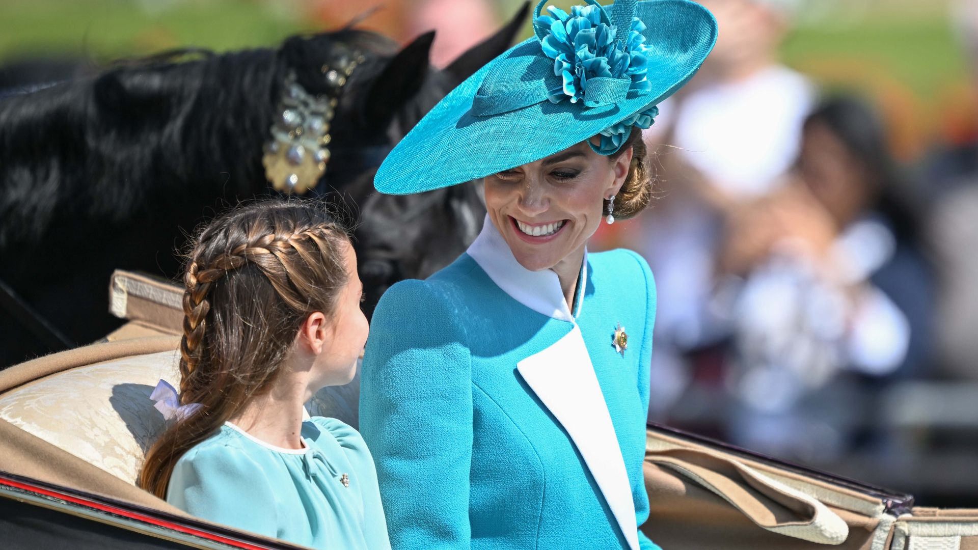 Catherine, Princess of Wales, shares a sweet moment with her daughter, Princess Charlotte, at the Trooping the Colour 2025 parade