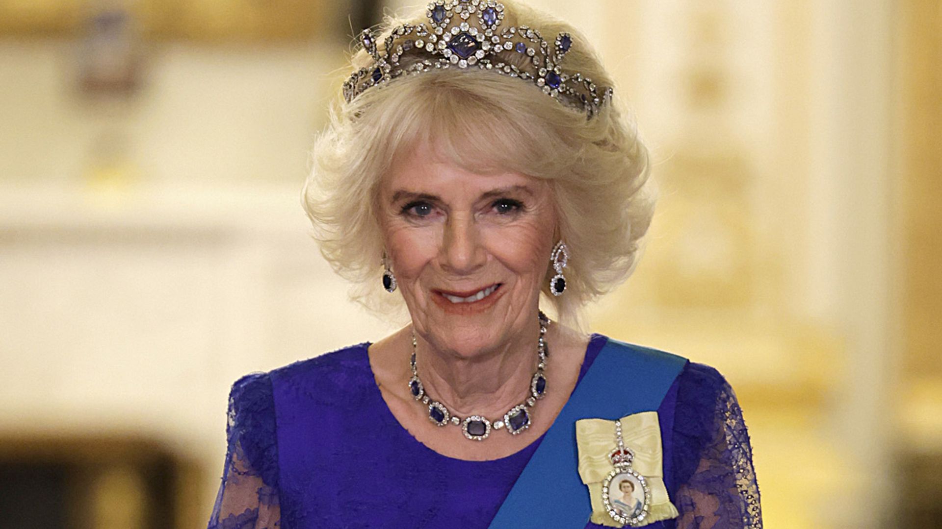 queen consort camilla wears tiara and blue dress