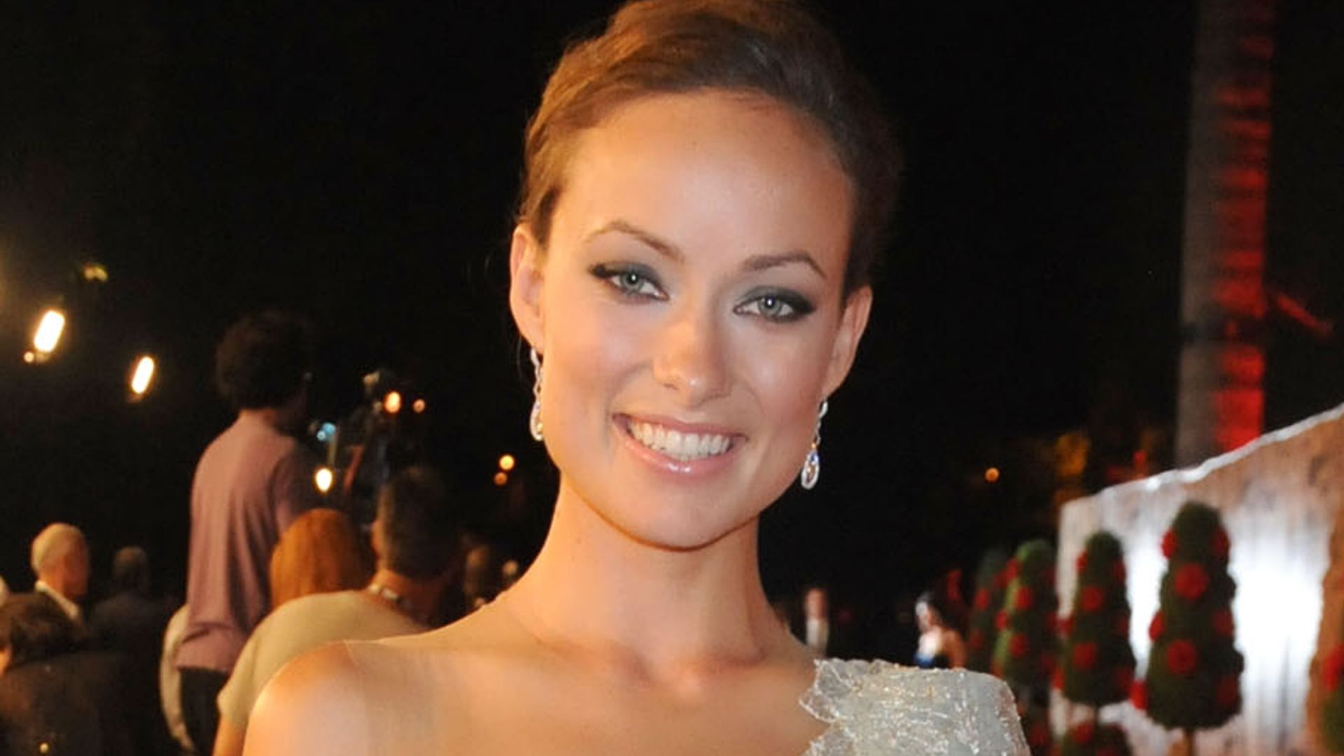 Olivia Wilde in a white gown on the red carpet of HBO's post Emmy Awards reception in 2009