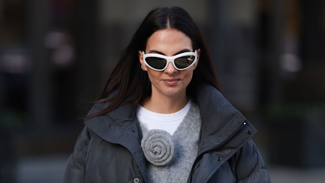 Street style image of a woman wearing a puffer jacket