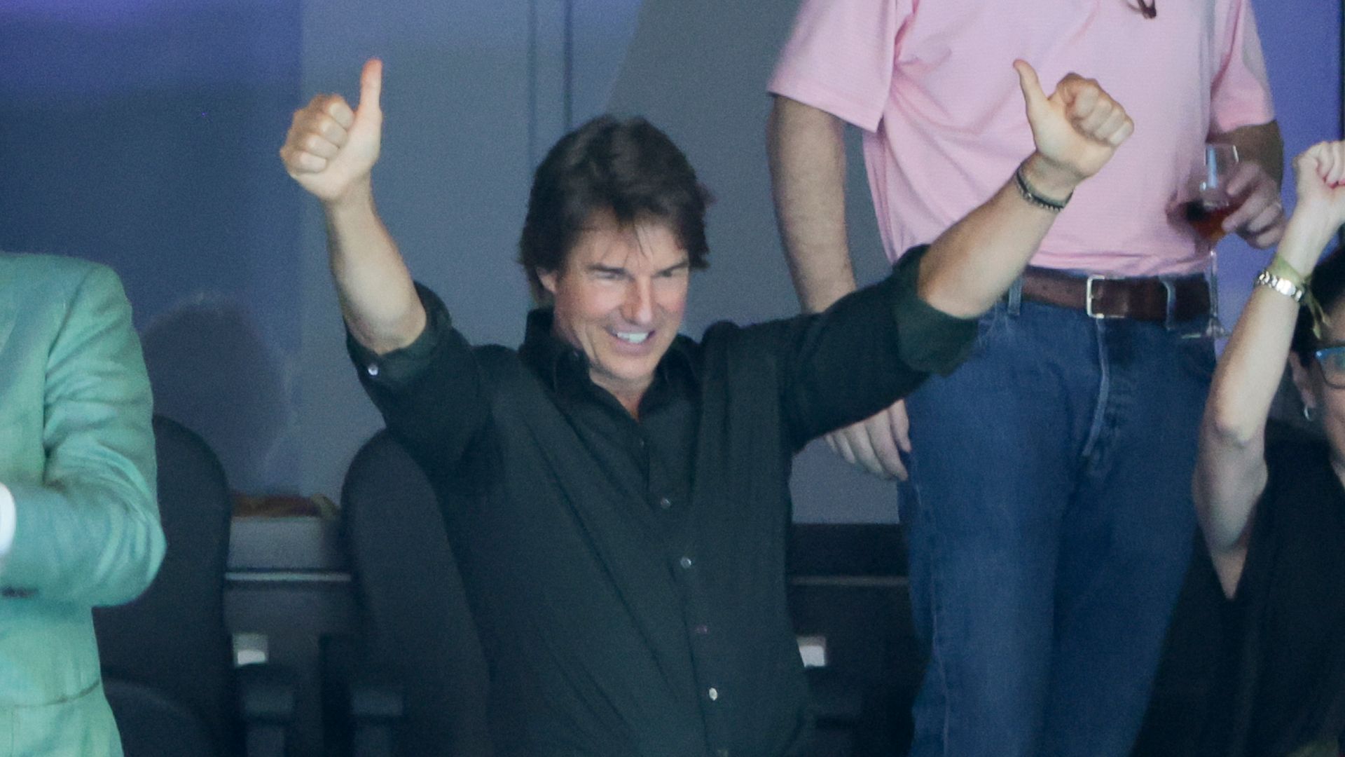 Tom Cruise celebrates winning the goal medal for the United States 4x100m freestyle relay during the first day of swimming competition at the Paris La Defense Arena on July 27, 2024 in Nanterre near Paris, France.