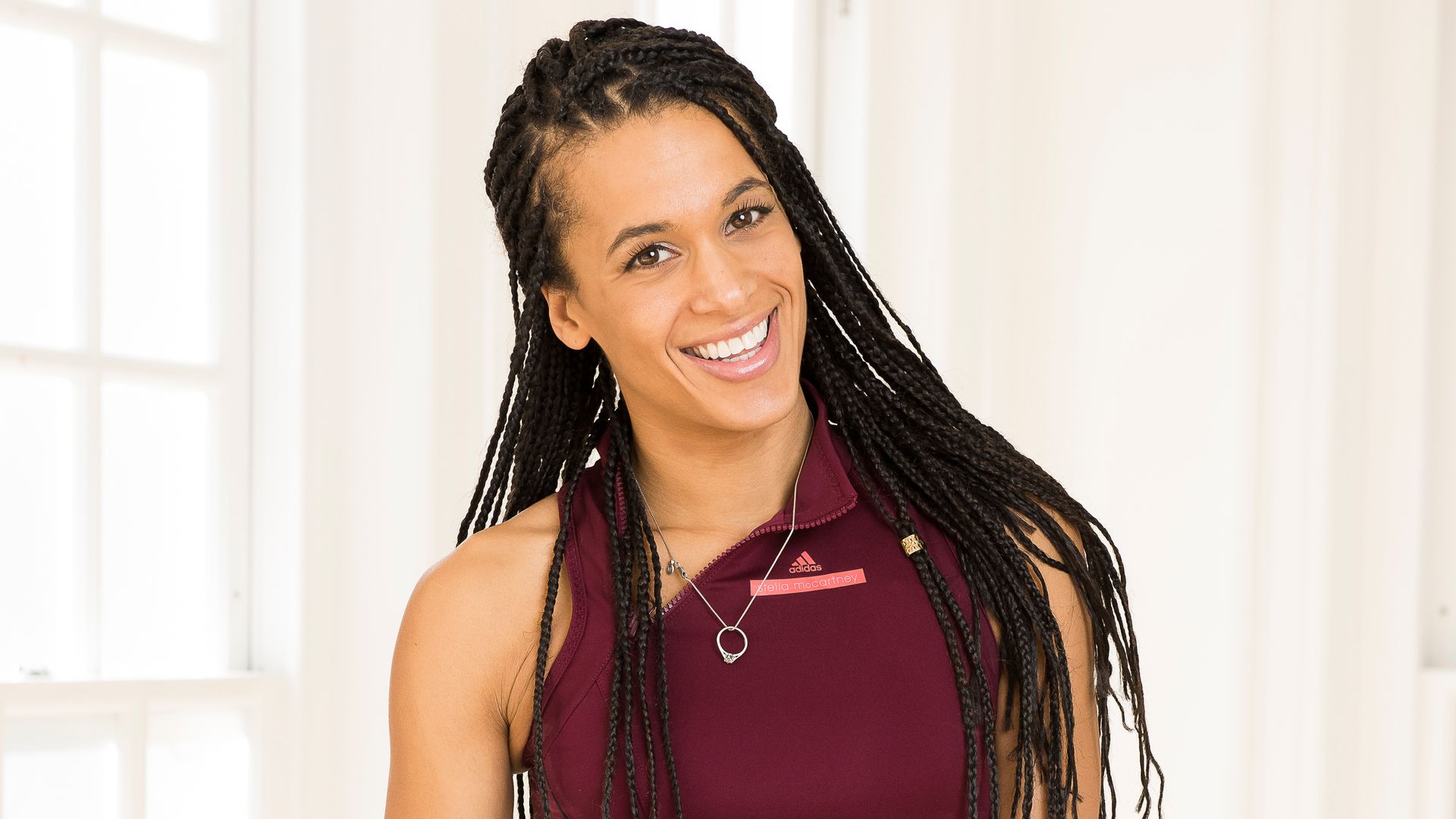 Beautiful woman smiling in a burgundy crop top